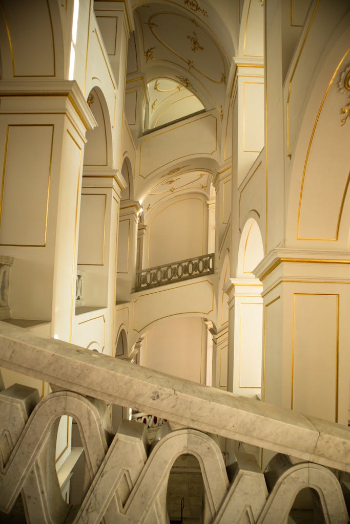 Stunning architectural interior showcasing elegant archways and columns with a warm light ambiance.